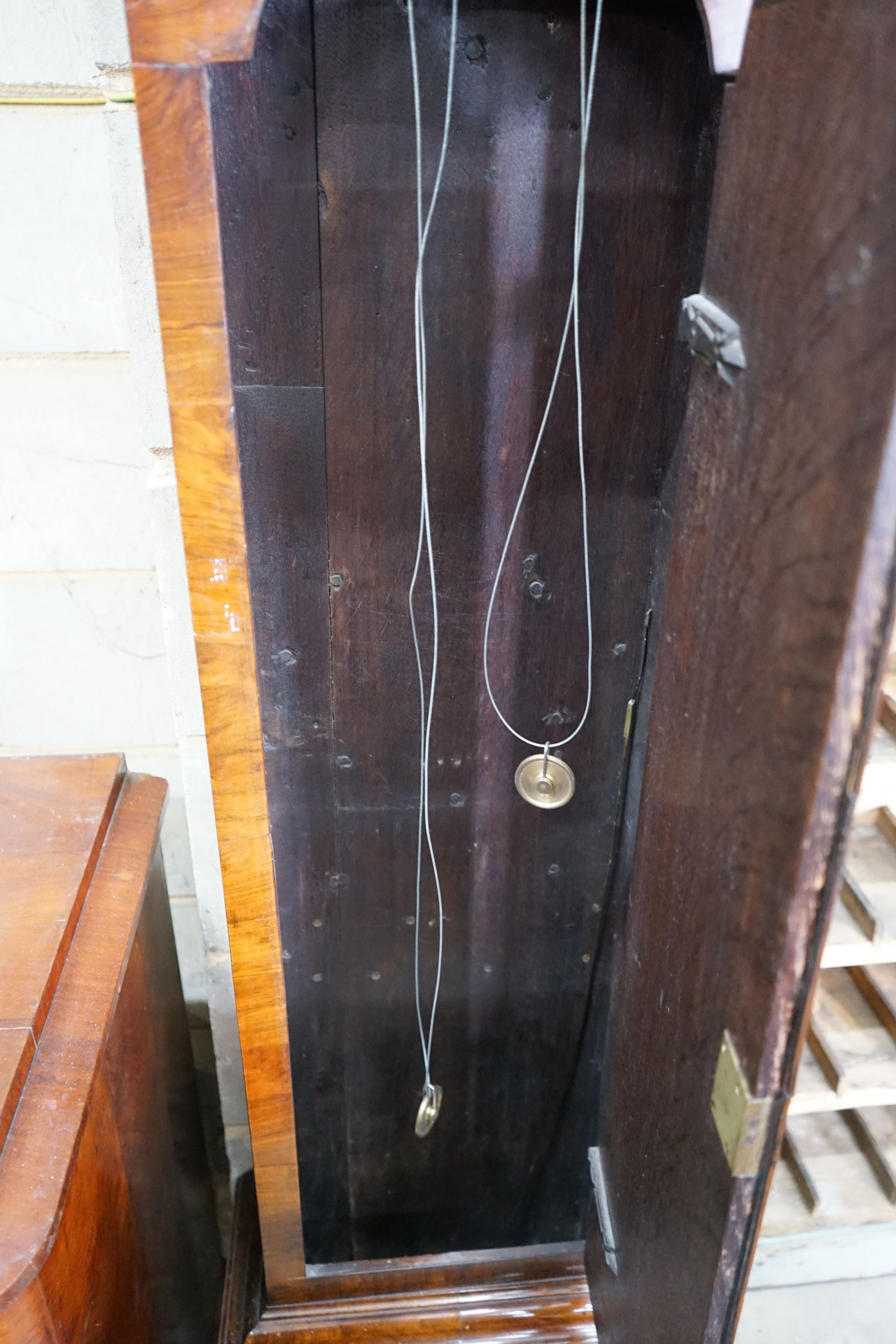 A George III feather banded walnut 8 day longcase clock, height approx. 250cm